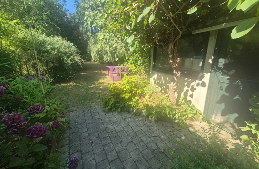 Maison bel étage de caractère avec grand jardin arboré et garage.